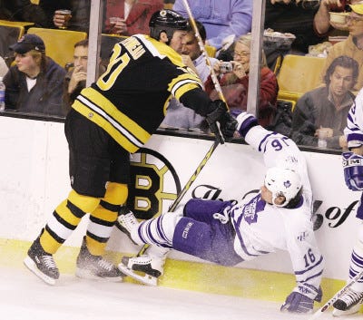 Bruins center Wayne Primeau drops Toronto Maple Leafs right wing Darcy Tucker during the first period. Primeau scored one of Boston's three third-period goals in the Bruins victory.