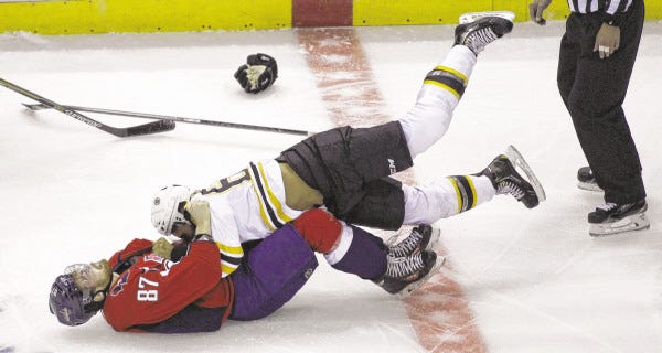 Washington Capitals' Liam O'Brien (87) and Boston Bruins' Bobby Robins, top, fight during the first period of a preseason hockey game, Friday, Sept. 26, 2014. The Capitals won 5-4 in overtime.