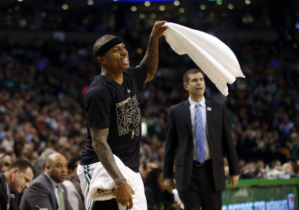 Celtics guard Isaiah Thomas waves a towel from the bench.